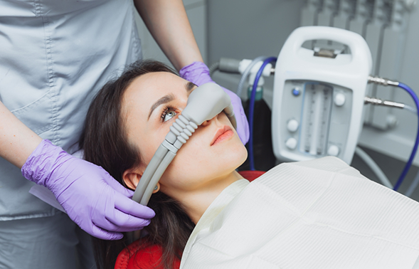 Dental patient with a nitrous oxide mask over her nose