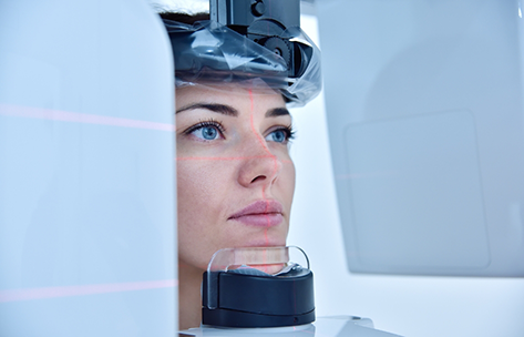 Woman getting a CT cone beam scan of her mouth and jaws