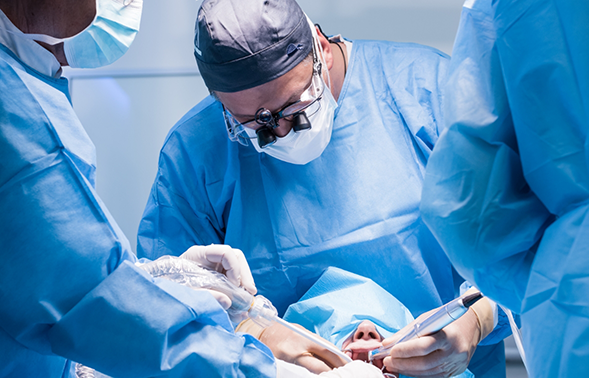 Oral surgeon performing dental implant surgery on a patient