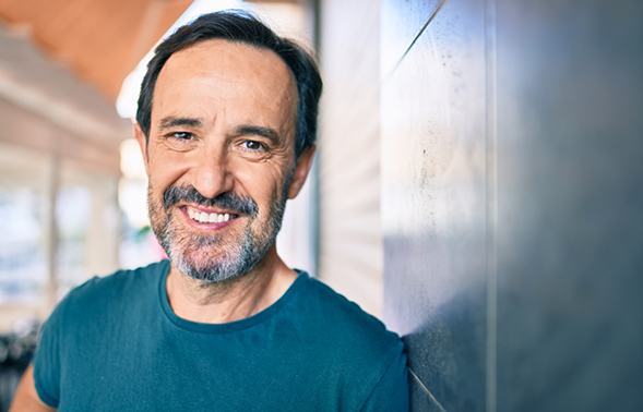 Smiling older man in a dark blue T shirt