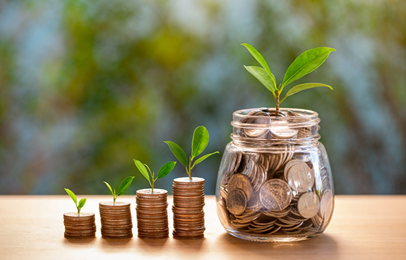 Jar of coins next to stacks of coins
