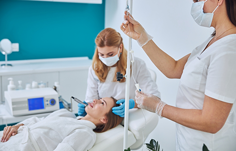 Oral surgeon and assistant treating a patient