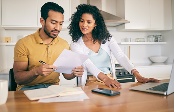Man and woman at a table looking at paperwork