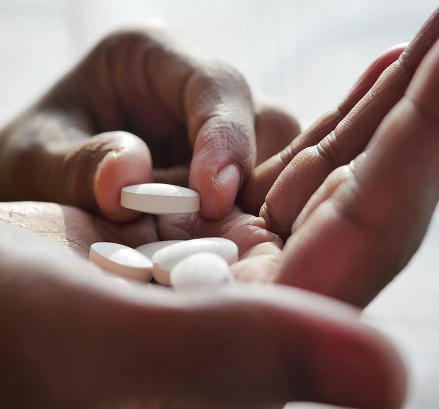 Person taking a white pill