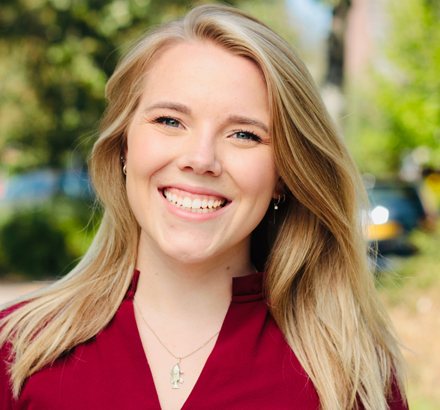 Blonde woman grinning after lip and tongue tie treatment in Prosper