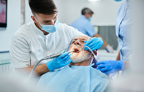 Senior man receiving periodontal treatment