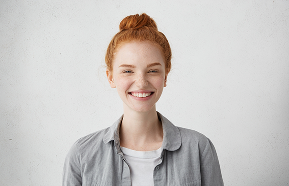 Young redheaded woman grinning