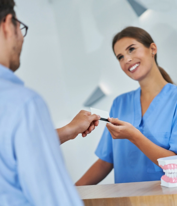 Patient paying for his dental treatment