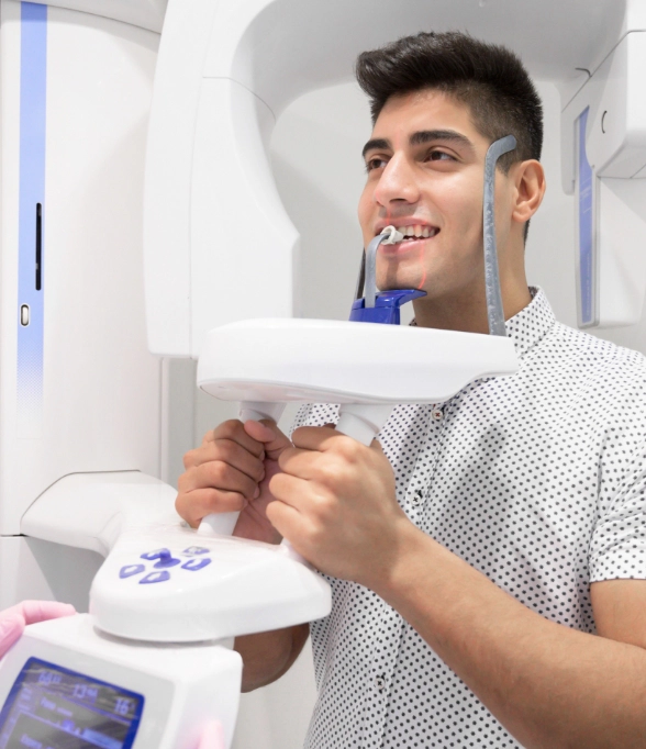 Young man getting a CT cone beam scan of his mouth and jaws