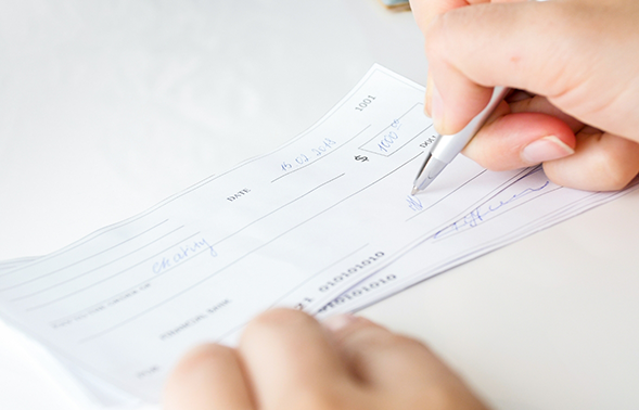 Person writing a check