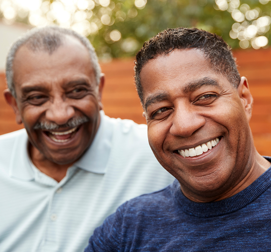 Two men smiling together after jaw surgery in Prosper