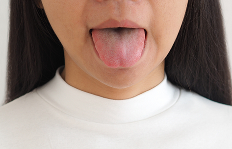 Close up of a person sticking out their tongue