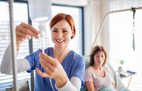 Nurse adjusting an IV