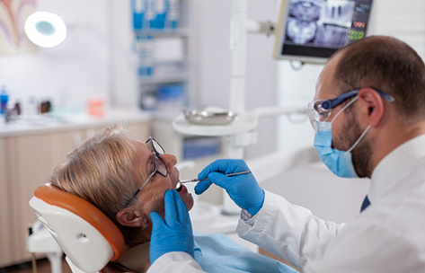 Dentist looking at a patient's mouth