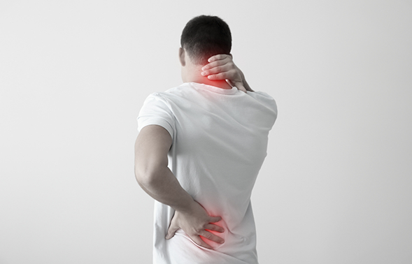 Man holding his lower back and the back of his neck in pain