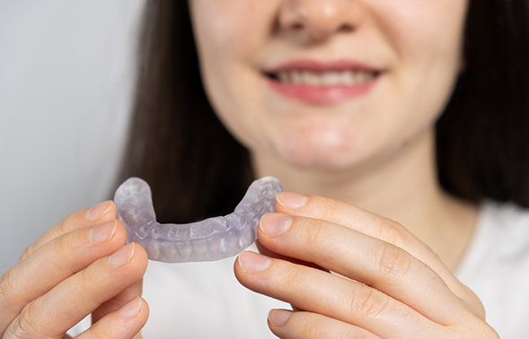 Woman holding an occlusal splint tray