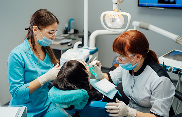Woman getting a tooth extraction
