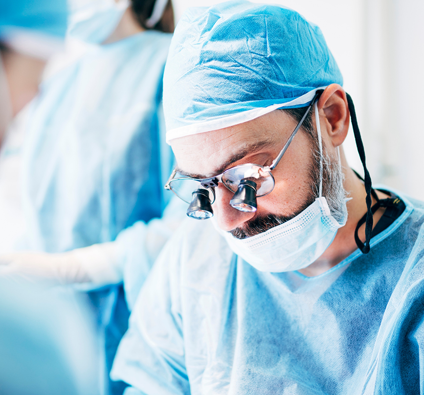 Oral surgeon performing wisdom tooth extractions on a patient